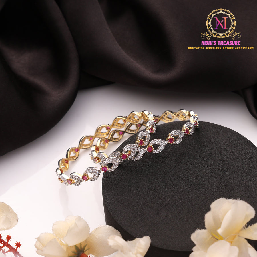 Golden Polish American Diamond Twisted Infinity Design Bangles with Ruby Red Stone Accents