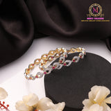 Golden Polish American Diamond Twisted Infinity Design Bangles with Ruby Red Stone Accents
